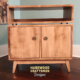 2X1.5 solid maple media console with upper turntable shelf, media equipment shelf, two divided storage compartments, two hardwood doors, and tapered mid-century legs.