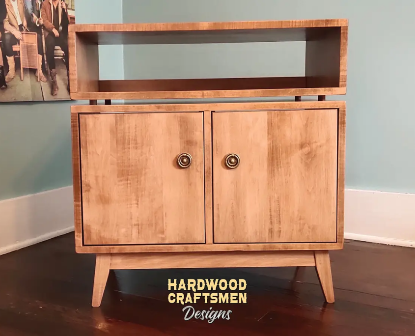 2X1.5 solid maple media console with upper turntable shelf, media equipment shelf, two divided storage compartments, two hardwood doors, and tapered mid-century legs.