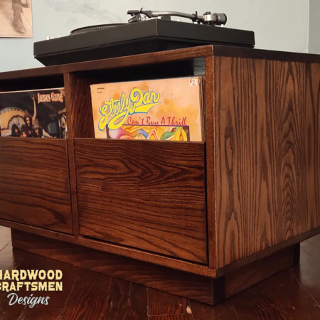 Dovetail 2 x 1 record storage console cabinet features 2 pull out vinyl drawers below a turntable shelf. This LP player stand is available in solid walnut, ash, red oak, maple, cherry and oak, all on a 3 inch 100% hardwood plinth base.