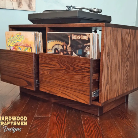 Dovetail 2 x 1 record player cabinet features 2 pull out vinyl storage drawers below a turntable shelf. This LP turntable stand is available in solid walnut, ash, red oak, maple, cherry and oak, all on a 3 inch 100% hardwood plinth base.
