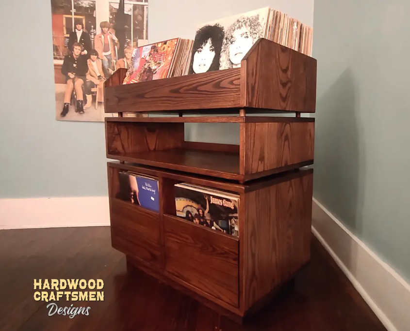 Dovetail 2 x 2.5 vinyl record shelves with equipment bay, 2 pull out storage drawers and 2 flip bins. This LP cabinet is available in solid walnut, ash, red oak, maple, cherry and oak, all on a 3 inch 100% hardwood plinth base.