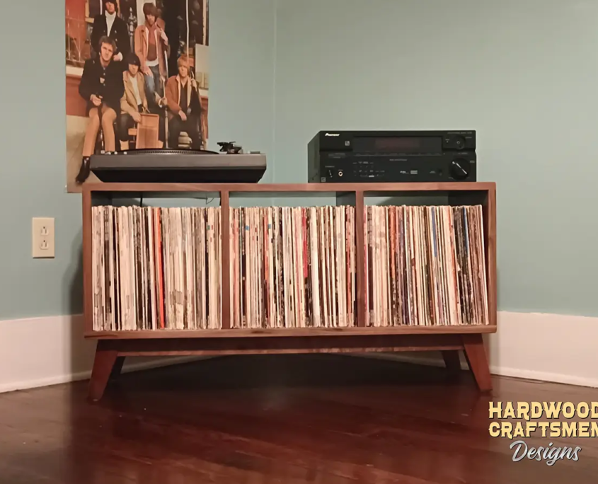 Low-profile solid walnut record console with turntable and media shelves, 3-bin storage, and tapered mid-century legs.