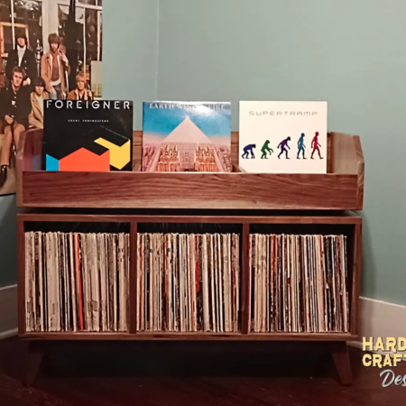 Large solid maple record cabinet with 3 upper vinyl flip bins, three divided storage compartments, and tapered mid-century legs with crossbars.