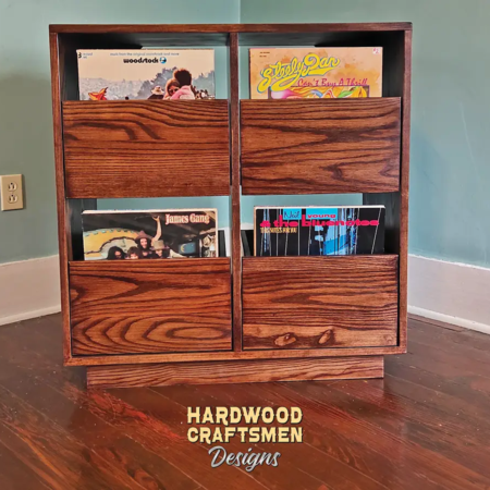 Dovetail 2 x 2 record player cabinet features 4 pull out vinyl storage drawers below a turntable and equipment shelf. This LP stand is available in solid walnut, ash, red oak, maple, cherry and oak, all on a 3 inch 100% hardwood plinth base.