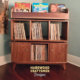 Solid walnut record storage cabinet with 2 doors & 3-to-5 LP flip bin compartments, available from 42-to-70-inches. This vinyl stand 3-tier features upper forward facing bins above 6-to-10 divided compartments, all on tapered mid-century legs.