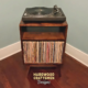 Record storage console in solid cherry features 1-to-4 lower bin storage below audio bays & turntable shelf. This media cabinet 2-tier is available from 20-to-48-inches, all on tapered mid-century legs.