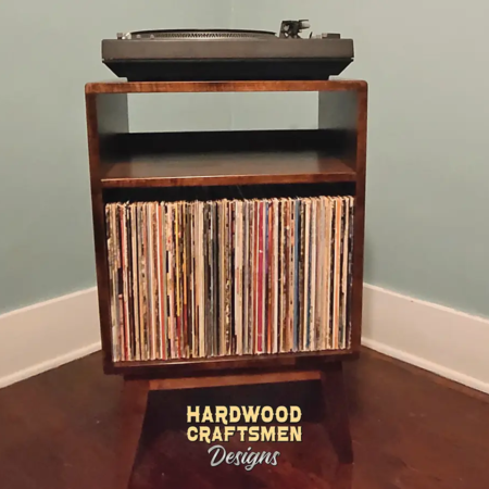 Small, narrow solid cherry dark-stain media console featuring an upper turntable shelf. The lower section includes a media cabinet with a storage compartment, all supported by tapered mid-century legs.