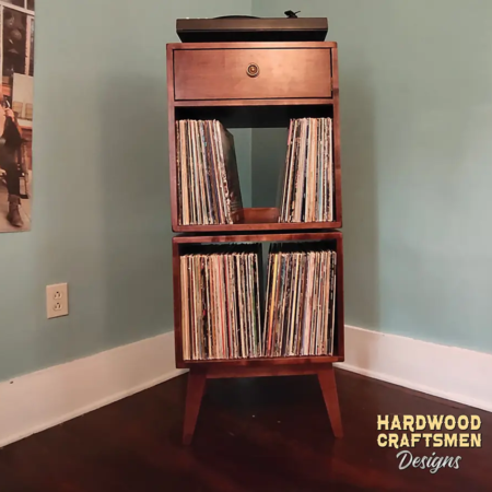 2-stack solid wood record stand with a turntable shelf, 1 dovetail drawer, 2 vinyl storage bins, and tapered mcm legs.