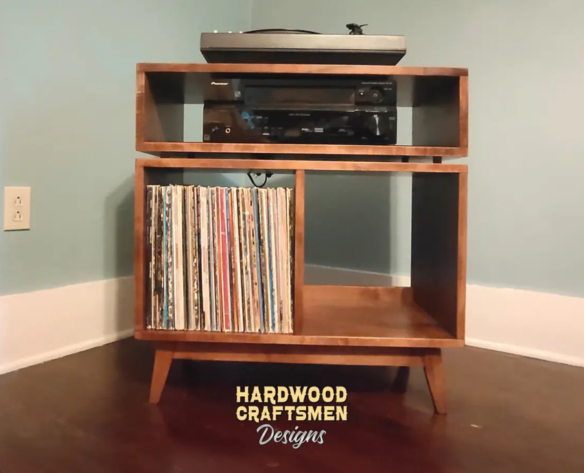 Solid wood record player cabinet, media console with a turntable shelf, media bay, 2 storage bins, and tapered mid-century legs.