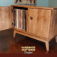Low profile solid maple 1 x 2 vinyl record storage featuring an upper turntable and media equipment shelf. The lower section includes a media cabinet with two hardwood doors and two divided storage compartments.