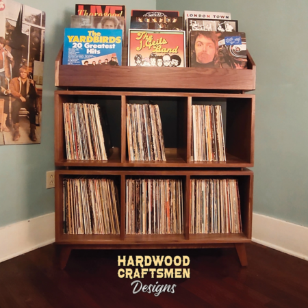 Solid walnut record storage cabinet featuring 9-to-15 LP flip bin compartments, available from 42-to-70-inches. This vinyl stand 5-tier features upper forward facing bins above 6-to-10 divided compartments, all on tapered mid-century legs.