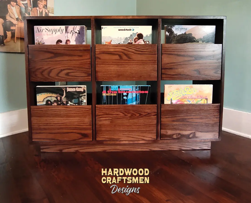 Dovetail 3 x 2 record player stand features 6 pull out vinyl storage drawers below a turntable and equipment shelf. This LP cabinet is available in solid walnut, ash, red oak, maple, cherry and oak, all on a 3 inch 100% hardwood plinth base.