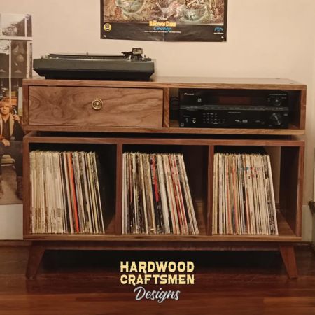 2-Level solid walnut media console featuring a turntable shelf, a media bay, a dovetail drawer, three open storage bins, and tapered mid-century legs.