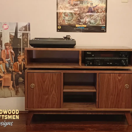 TV stand in solid walnut wood with doors 3 x 1.5 with 3 vinyl bin compartments, available from 42 to 72 inches. This record player cabinet 3 x 1.5 & media credenza features an upper TV shelf above three divided compartments, all on tapered mid-century legs.
