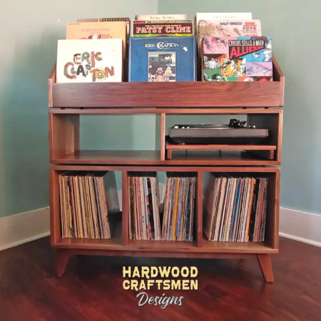 Large solid walnut record cabinet with nine vinyl flip bins, custom pull-out turntable shelf, three open storage compartments, and tapered mid-century legs.