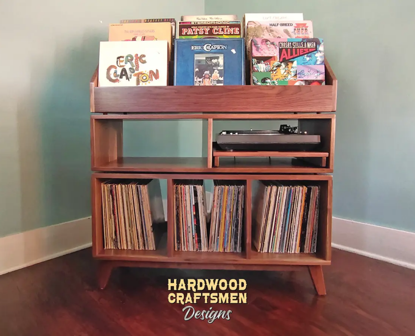 Large solid walnut record cabinet with nine vinyl flip bins, custom pull-out turntable shelf, three open storage compartments, and tapered mid-century legs.