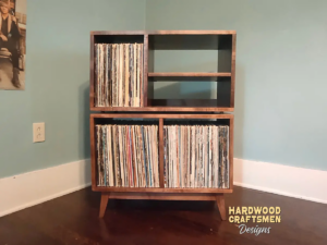 Large 2x2 solid wood record stand featuring a turntable and media shelves, four open vinyl storage compartments, and tapered mid-century legs.