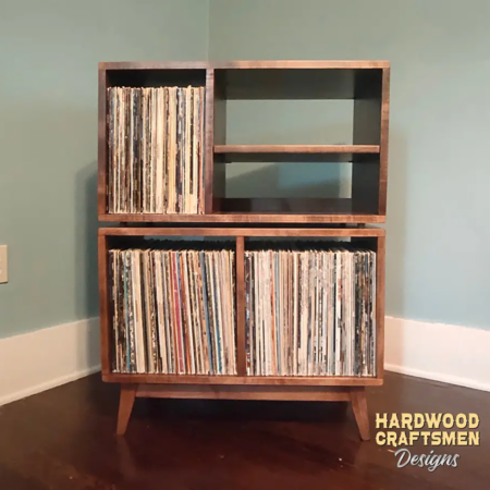 Large 2x2 solid wood record stand featuring a turntable and media shelves, four open vinyl storage compartments, and tapered mid-century legs.