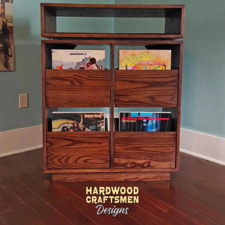 Dovetail 2 x 2.5 record player stand features 4 pull out vinyl storage drawers below an audio equipment and turntable shelf. This record cabinet is available in solid walnut, ash, red oak, maple, cherry and oak, all on a 3 inch 100% hardwood plinth base.