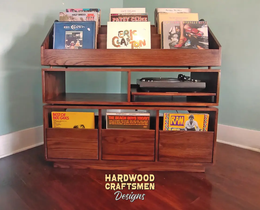 Dovetail 3 x 3 vinyl record shelves with equipment bays, 3 pull out storage drawers and 9 flip bins. This LP cabinet is available in solid walnut, ash, red oak, maple, cherry and oak, all on a 3 inch 100% hardwood plinth base.