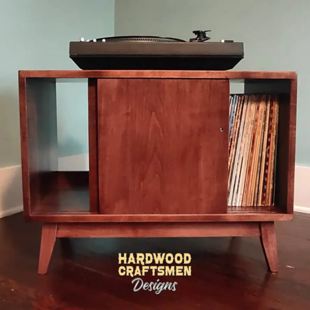 Low profile solid maple mid-century style record cabinet featuring an upper turntable and media equipment shelf. The lower section includes a media cabinet with two open sliding doors and two divided storage compartments.