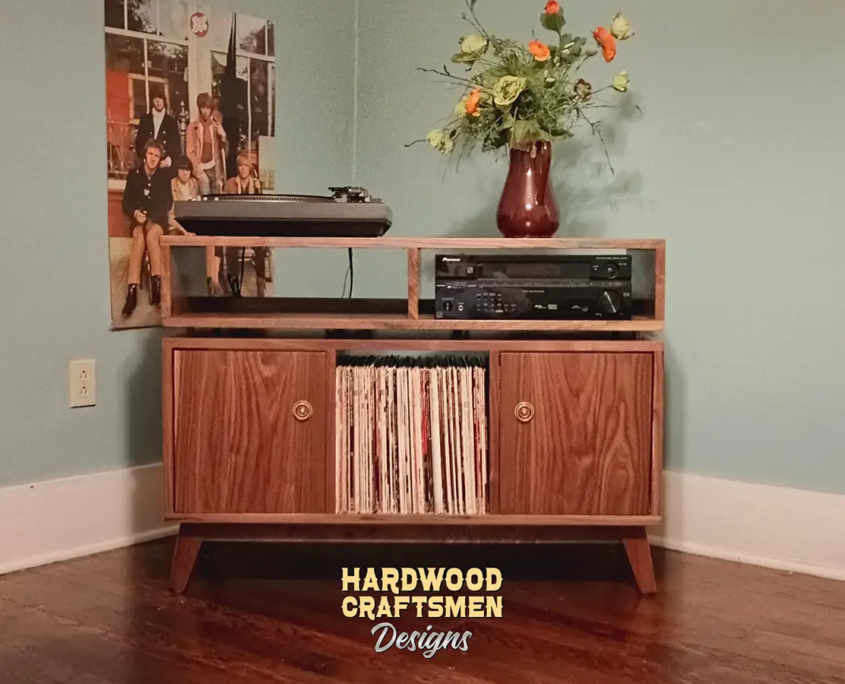 Solid walnut record storage cabinet with 2 doors 3 x 1.5 with 3 vinyl bin compartments, available from 42 to 72 inches. This media stand & console features an upper TV shelf above three divided compartments, all on tapered mid-century legs.