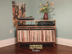 Solid walnut record player cabinet & vinyl storage with 3 bin compartments, available from 42 to 72 inches. This credenza console features an upper TV shelf above three divided storage compartments, with two hardwood media bays, all on tapered mid-century legs.