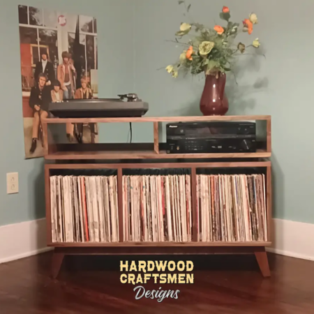 Solid walnut record player cabinet & vinyl storage with 3 bin compartments, available from 42 to 72 inches. This credenza console features an upper TV shelf above three divided storage compartments, with two hardwood media bays, all on tapered mid-century legs.