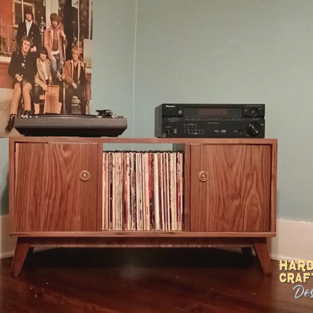 Solid walnut record player stand with 2 cabinet doors, available from 42 to 72 inches, featuring an upper TV shelf above three divided storage compartments, with two outer hardwood doors covering the side compartments, all on tapered mid-century legs.