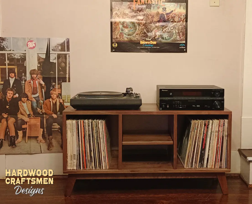 3X1 low-profile solid walnut media console with upper TV stand shelf, turntable and media equipment shelves, three divided storage compartments, and tapered mid-century legs.