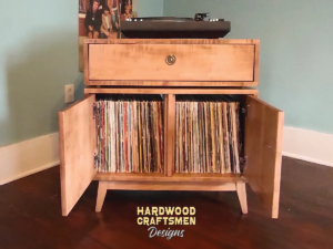 2-level solid wood record console with a turntable shelf, dovetail drawer, 2-door, 2 storage bins, and tapered mcm legs.
