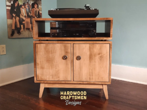 2-level solid maple record console with a turntable shelf, 2-door, 2 storage bins, and tapered mid-century legs.