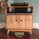 2-level solid maple record console with a turntable shelf, 2-door, 2 storage bins, and tapered mid-century legs.