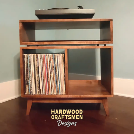Low-profile solid wood record console with a turntable shelf, media bay, 2 storage cubbies, and tapered mcm legs.