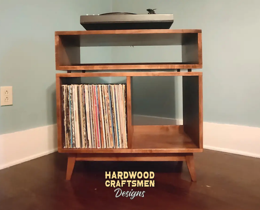 Low-profile solid wood record console with a turntable shelf, media bay, 2 storage cubbies, and tapered mcm legs.