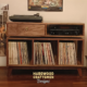 Solid walnut record player cabinet with a dovetail drawer and 3 vinyl storage bin compartments, available from 42 to 72 inches. This Media console features an upper TV shelf above three divided compartments, all on tapered mid-century legs.