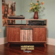 2-Level solid walnut media console featuring a turntable shelf, a media bay, two hinged doors with open storage bin, and tapered mid-century legs.
