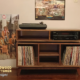Solid walnut media storage cabinet solid walnut 3 x 1.5 with 3 vinyl bin compartments, available from 42 to 72 inches. This record player stand & console features an upper TV shelf above three divided storage compartments, with two hardwood media bays, all on tapered mid-century legs.