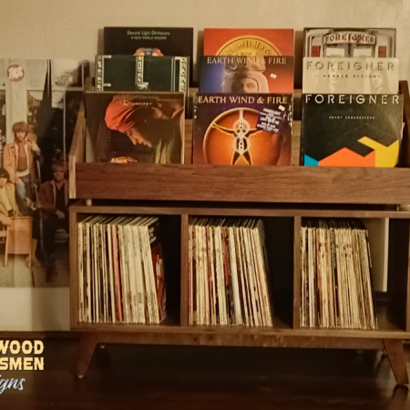 Large solid walnut record cabinet with 9 upper vinyl flip bins, six divided storage compartments, and tapered mid-century legs with crossbars.