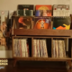 Solid walnut record storage cabinet features 3-to-5 vertical bins below 9-to-15 LP flip bin compartments, This vinyl stand 4-tier is available from 42-to-70-inches, all on tapered mid-century legs.