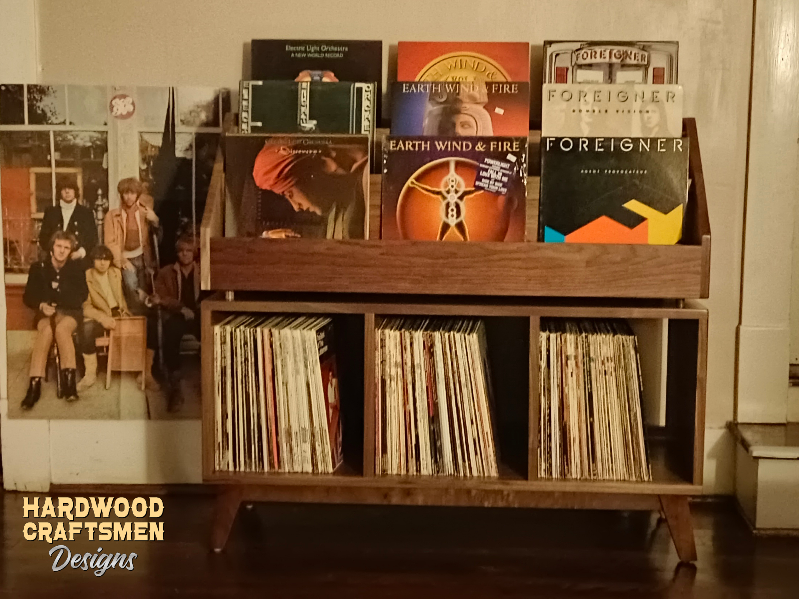 Solid walnut record cabinet with 9 upper vinyl flip bins, six divided storage compartments, and tapered mid-century legs with crossbars.