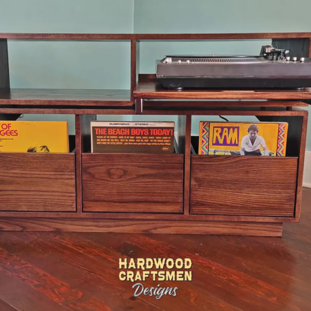 Dovetail 3 x 2 record player cabinet features a custom turntable shelf, 3 pull out LP drawers below audio equipment shelves. This custom vinyl storage stand is available in solid walnut, ash, red oak, maple, cherry and oak, all on a 3 inch 100% hardwood plinth base.