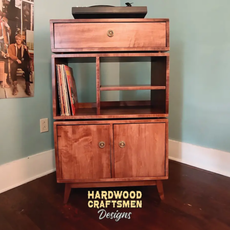 Vinyl record storage cabinet with dovetail drawers 3-tier layout with 3 vinyl bin compartments, available from 42 to 72 inches. This Media stand 2-door in solid maple features an upper audio shelves above four divided compartments, all on tapered mid-century legs.