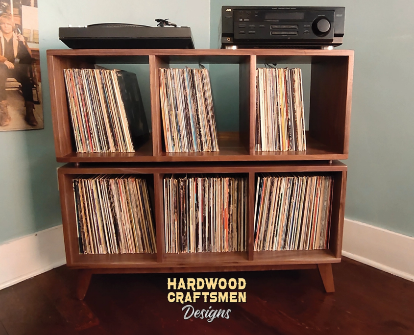 Solid walnut record player cabinet 3 x 2 layout with 6 vinyl bin compartments, available from 42 to 72 inches. This media console 3 x 2 & audio stand features an upper media bays above six divided compartments, all on tapered mid-century legs.