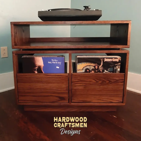 Dovetail 2 x 1.5 record console cabinet features 2 pull out LP storage drawers below an audio equipment shelf. This vinyl stand is available in solid walnut, ash, red oak, maple, cherry and oak, all on a 3 inch 100% hardwood plinth base.