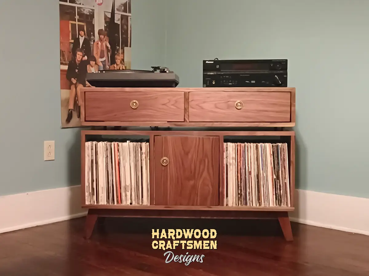 Vinyl storage cabinet with dovetail drawers 3 x 1.5 with 3 vinyl bin compartments, available from 42 to 72 inches. This media console in solid walnut features an upper TV shelf above three divided compartments, all on tapered mid-century legs.