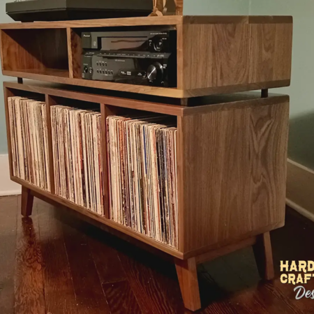 Solid walnut record player stereo console & vinyl storage with 3 bin compartments, available from 42 to 72 inches. This credenza cabinet features an upper TV shelf above three divided storage compartments, with two hardwood media bays, all on tapered mid-century legs.