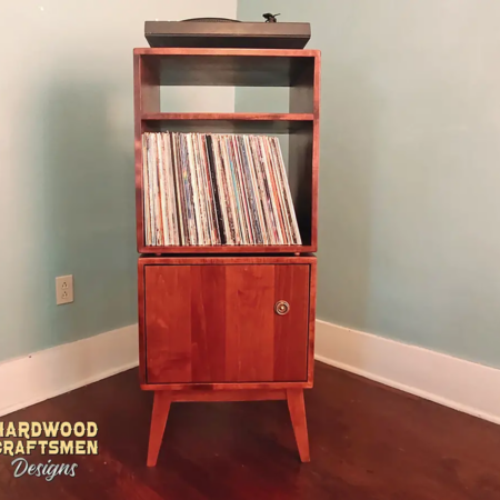 Record storage cabinet with doors & audio bays featuring 2-to-6 lower bins below equipment bays & turntable shelf. This media stand 3-tier in solid cherry is available from 20-to-48-inches, all on tapered mid-century legs.