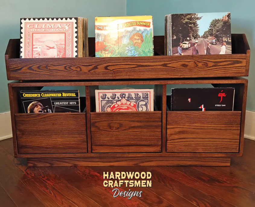 Dovetail 3 x 2 vinyl storage cabinet features 3 pull out drawers below 3 flip bins. This LP cabinet is available in solid walnut, ash, red oak, maple, cherry and oak, all on a 3 inch 100% hardwood plinth base.