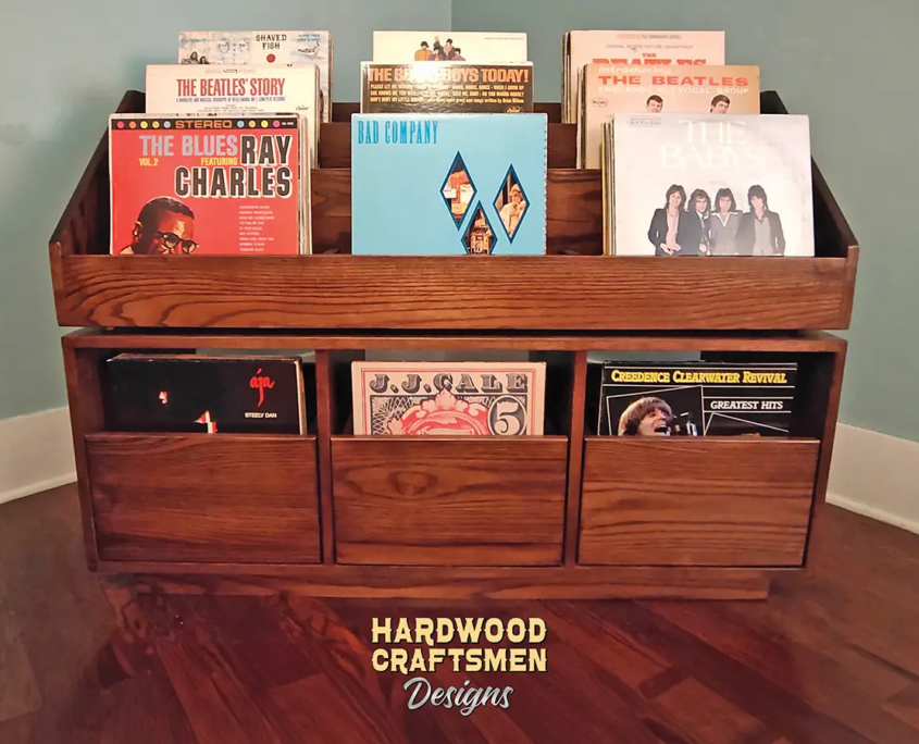 Dovetail 3 x 2 vinyl record shelves with 3 pull out storage drawers and 9 flip bins. This LP cabinet is available in solid walnut, ash, red oak, maple, cherry and oak, all on a 3 inch 100% hardwood plinth base.